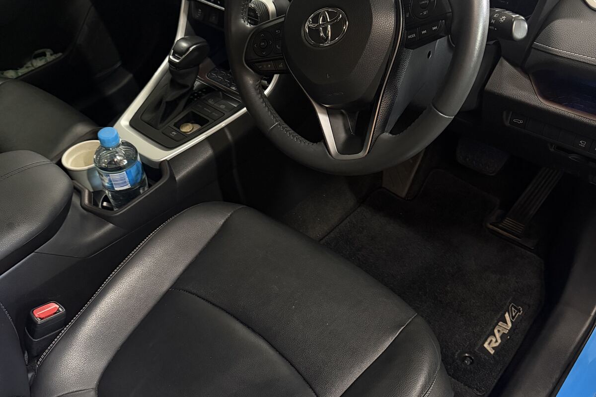The cleaned interior of a Toyota RAV4, console and leather seat, after a maintenance detail by Jayden Nelson