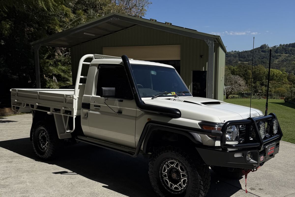 A white single-cab LandCruiser work ute finished by Jayden Nelson, parked on a rural property